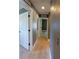 Bright hallway with tile floors, white doors, and neutral gray walls with contrasting trim at 6172 Raleigh St, Spring Hill, FL 34606