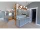 Stylish kitchen featuring gray cabinets, granite countertops, wooden accents, and modern lighting fixtures at 6172 Raleigh St, Spring Hill, FL 34606