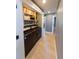 Convenient laundry area with modern washer and dryer, and built-in shelving for supplies at 6172 Raleigh St, Spring Hill, FL 34606