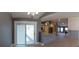 Open-concept living area features a modern kitchen, dining space, and sliding glass door access to the patio at 6172 Raleigh St, Spring Hill, FL 34606