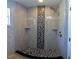 Modern shower with stone-look tiling, decorative accents, and dual built-in shelves at 6172 Raleigh St, Spring Hill, FL 34606