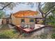 Backyard boasts a deck area with umbrella and comfortable seating at 6315 Shane Ln, New Port Richey, FL 34653