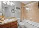 Bathroom with single sink vanity and shower-tub combo with glass enclosure at 6315 Shane Ln, New Port Richey, FL 34653