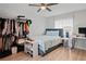 Cozy bedroom with neutral walls, ceiling fan, hardwood floors, and a big window for natural light at 6315 Shane Ln, New Port Richey, FL 34653