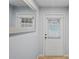 Bright entryway featuring a white door, neutral walls, and a decorative mirror at 6315 Shane Ln, New Port Richey, FL 34653