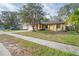 Charming single-story home with well-maintained front yard and mature trees providing shade at 6315 Shane Ln, New Port Richey, FL 34653