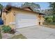 Garage with a driveway and landscaping at 6315 Shane Ln, New Port Richey, FL 34653