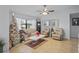 Well-lit living room with neutral decor, comfortable seating, and tile floors at 6315 Shane Ln, New Port Richey, FL 34653