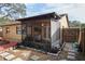 Relaxing screened lanai with a ceiling fan, outdoor seating, and a view of the backyard at 6315 Shane Ln, New Port Richey, FL 34653