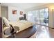 Bright bedroom with sliding glass doors, hardwood floors, and stylish decor at 700 Starkey Rd # 622, Largo, FL 33771