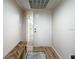 Inviting entryway featuring a bench seat, stylish rug, wood floors, and a sidelight front door at 700 Starkey Rd # 622, Largo, FL 33771