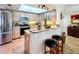 Bright, open kitchen with granite countertops, stainless steel appliances, and breakfast bar seating at 700 Starkey Rd # 622, Largo, FL 33771