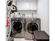 Laundry room featuring a washer and dryer with white upper cabinets at 700 Starkey Rd # 622, Largo, FL 33771