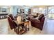 Inviting living room featuring hardwood floors, comfortable leather seating, and a large TV at 700 Starkey Rd # 622, Largo, FL 33771