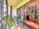 Inviting screened patio featuring a dining set, potted plant, and view of green outdoor space at 700 Starkey Rd # 622, Largo, FL 33771