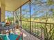 Screened-in patio with table and chairs overlooking landscaped lawn at 700 Starkey Rd # 622, Largo, FL 33771