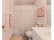 Classic bathroom featuring a floral shower curtain, white toilet and vanity, and patterned wallpaper at 7392 Willow Brook Dr, Spring Hill, FL 34606