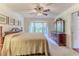 Bedroom with a traditional-style bed, dresser, and a bay window offering ample natural light at 7392 Willow Brook Dr, Spring Hill, FL 34606