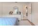 Bright bedroom showcasing a wicker dresser, blue bedding, and an open doorway to another room at 7392 Willow Brook Dr, Spring Hill, FL 34606