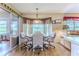 Cozy breakfast nook featuring light fixtures, backyard views, and seating for four at 7392 Willow Brook Dr, Spring Hill, FL 34606