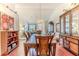 Spacious dining room featuring hardwood floors, a decorative chandelier, and access to living areas at 7392 Willow Brook Dr, Spring Hill, FL 34606