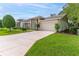 Charming home featuring a well-manicured lawn and a two-car garage at 7392 Willow Brook Dr, Spring Hill, FL 34606