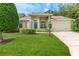 Charming single-story home featuring a well-manicured lawn and a two-car garage at 7392 Willow Brook Dr, Spring Hill, FL 34606