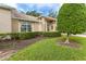 Well-maintained front yard with lush greenery and attractive landscaping at 7392 Willow Brook Dr, Spring Hill, FL 34606