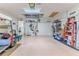 Spacious garage with ample storage, featuring golf cart parking and organization solutions at 7392 Willow Brook Dr, Spring Hill, FL 34606