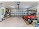 Clean garage featuring space for golf cart parking, storage shelves, and well-lit interior at 7392 Willow Brook Dr, Spring Hill, FL 34606