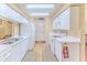 Bright kitchen featuring white cabinets and appliances, leading into a dining space at 7392 Willow Brook Dr, Spring Hill, FL 34606