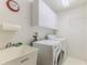 Well-lit laundry room with a utility sink, washing machine, and dryer at 7392 Willow Brook Dr, Spring Hill, FL 34606