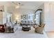 Spacious living room with vaulted ceilings, ceiling fan, and abundant natural light at 7392 Willow Brook Dr, Spring Hill, FL 34606