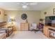Inviting living room with a ceiling fan, comfortable seating, neutral walls, and a large area rug at 7392 Willow Brook Dr, Spring Hill, FL 34606