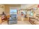 Cozy living room featuring comfortable seating and an open view to the kitchen and dining area at 7392 Willow Brook Dr, Spring Hill, FL 34606