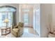 Bright and airy living room with a view of the front yard and a cozy recliner at 7392 Willow Brook Dr, Spring Hill, FL 34606