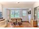 Bright sunroom with desk, chairs, and backyard views at 7392 Willow Brook Dr, Spring Hill, FL 34606