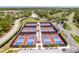 Overhead view of modern pickleball courts surrounded by palm trees in a vibrant community at 7392 Willow Brook Dr, Spring Hill, FL 34606