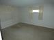 Bedroom with neutral carpet and walls, and natural lighting from the windows at 7421 Fairfax Dr, Port Richey, FL 34668