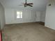 Bright living room with neutral carpet, ceiling fan and natural light at 7421 Fairfax Dr, Port Richey, FL 34668