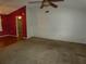 Spacious living room with neutral carpet flooring and a ceiling fan at 7421 Fairfax Dr, Port Richey, FL 34668
