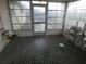 Sun room featuring decorative black and white mosaic tile, and exterior view at 7421 Fairfax Dr, Port Richey, FL 34668