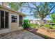 Paver patio featuring access to a sunroom surrounded by mature landscaping at 7802 Hardwick Dr # 1116, New Port Richey, FL 34653