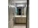 This bathroom features a single sink vanity with a mirror, lighting and tile floors at 7802 Hardwick Dr # 1116, New Port Richey, FL 34653