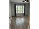 Bright bedroom with gray laminate flooring and shuttered windows at 7802 Hardwick Dr # 1116, New Port Richey, FL 34653