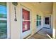 View of a front doorway with an alarm sign, and a storm door at 7802 Hardwick Dr # 1116, New Port Richey, FL 34653