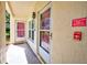 View of a front doorway with an alarm sign, and a storm door at 7802 Hardwick Dr # 1116, New Port Richey, FL 34653