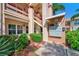 View of a condominium building exterior with lush landscaping and stairs to the upper units at 7802 Hardwick Dr # 1116, New Port Richey, FL 34653