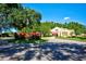 Lovely exterior view showcasing the manicured landscaping and well-maintained building against a vibrant blue sky at 7802 Hardwick Dr # 1116, New Port Richey, FL 34653