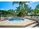 Relax in the community hot tub area surrounded by manicured landscaping and paver flooring at 7802 Hardwick Dr # 1116, New Port Richey, FL 34653